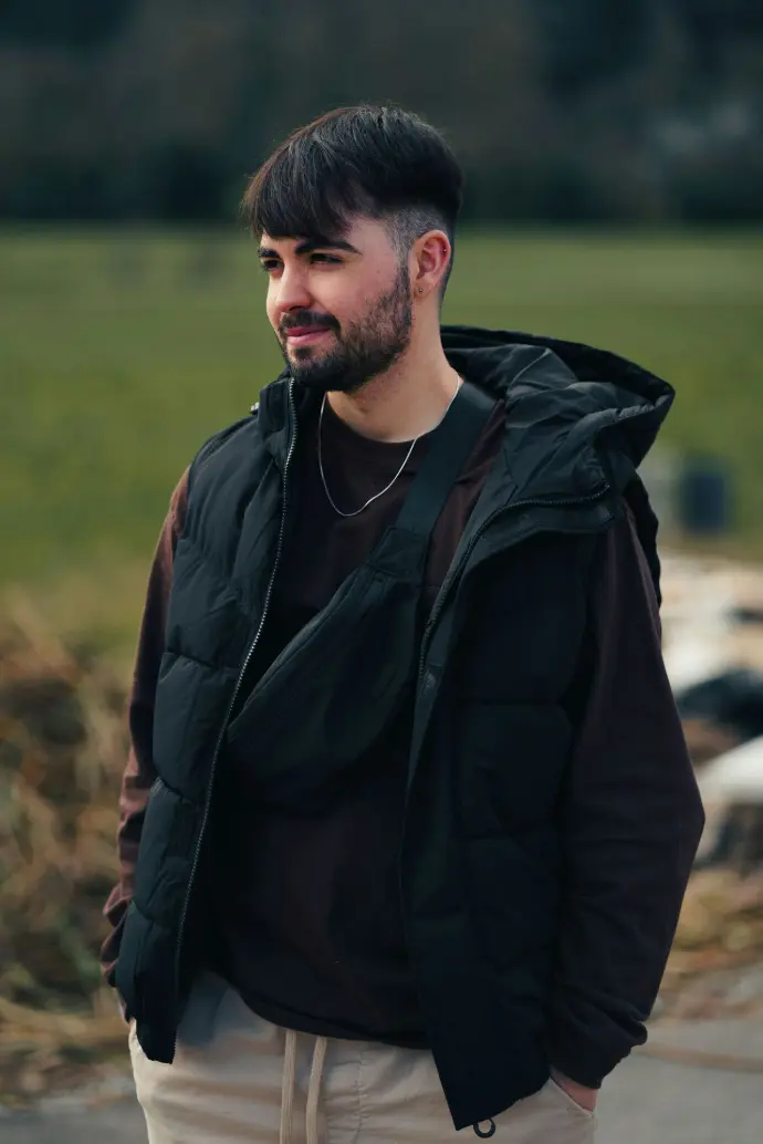 a man with a beard wearing a black jacket